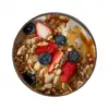 Coconut Shell Breakfast Bowl Top View Top view of a coconut shell bowl filled with yogurt, granola, strawberries, blueberries and banana