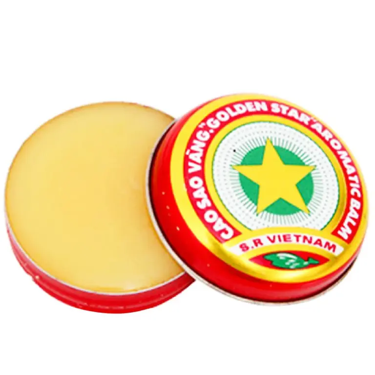 Open tin of Golden Star Balm 3g with yellow herbal balm and red Vietnamese packaging